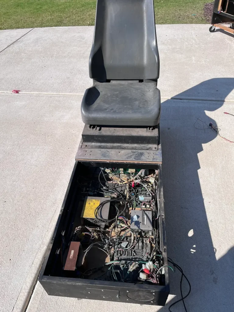 Daytona USA base cabinet open with PCBs exposed.