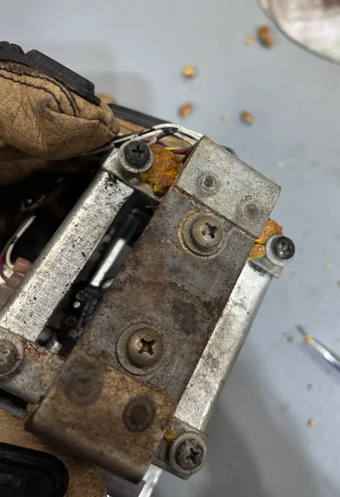 Daytona USA gear shifter close-up of deteriorated components before restoration