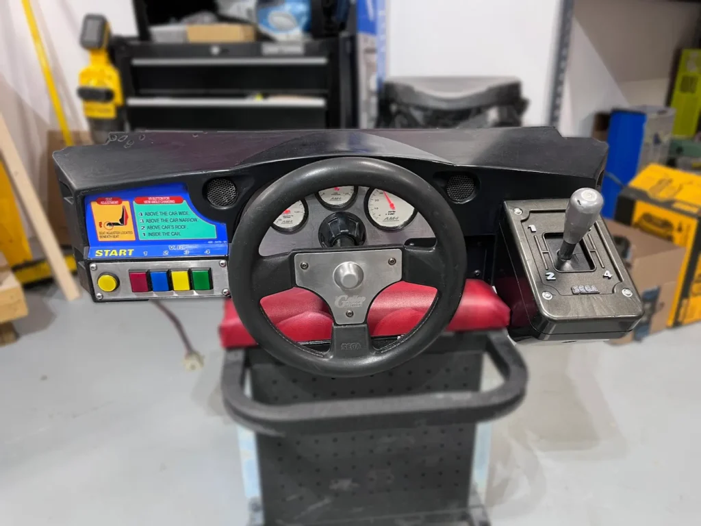 Daytona USA Twin cab steering control panel removed from vertical cabinet.